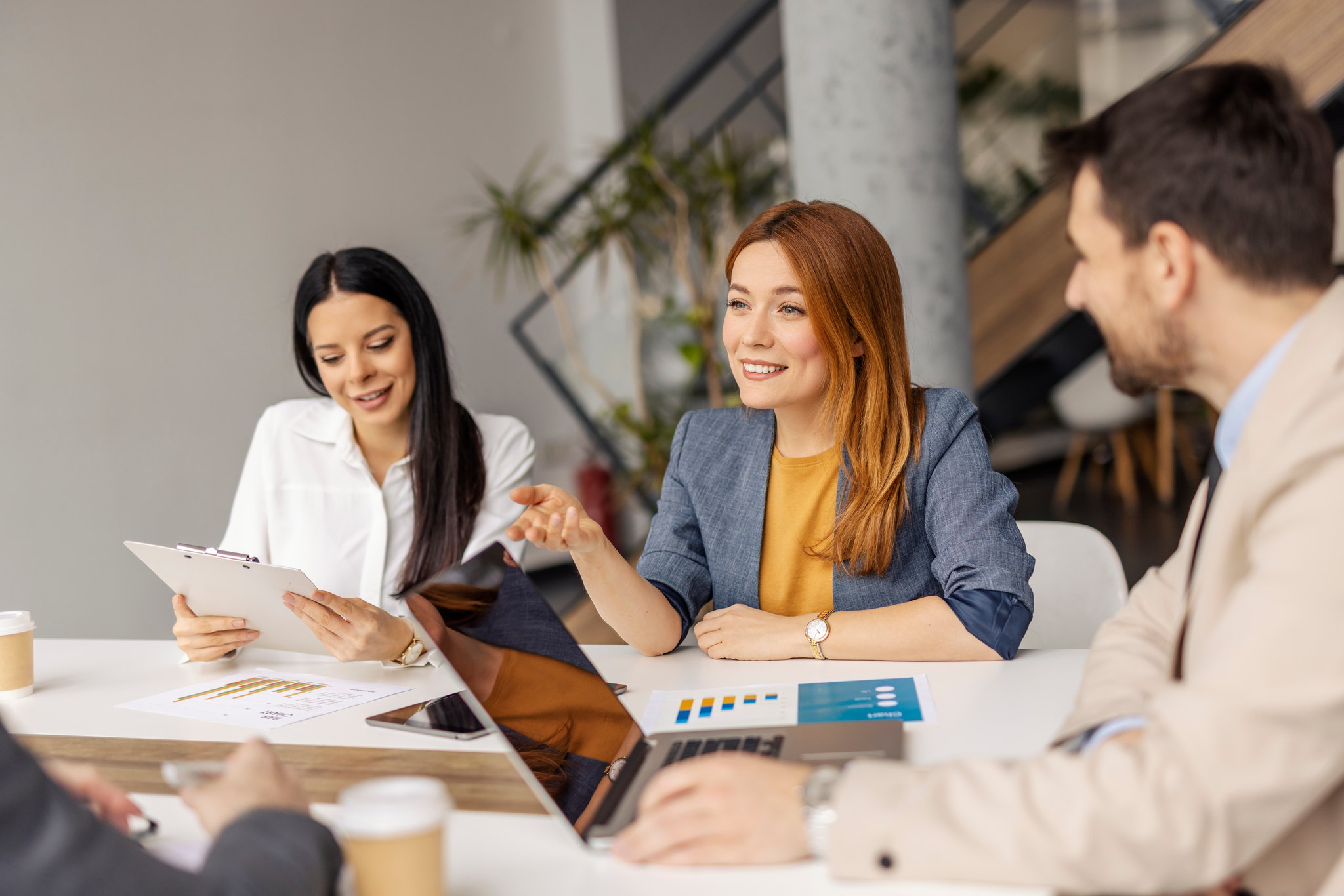 Advisors reviewing a client's PEO arrangement across a meeting table