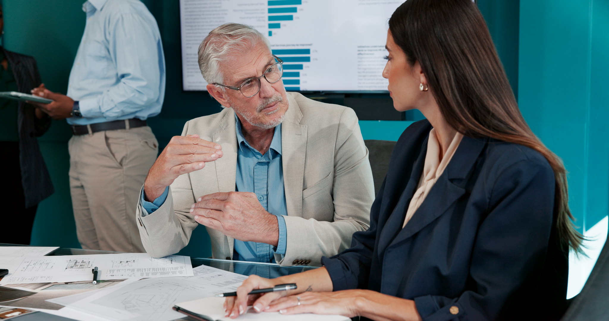 Advisor reviewing provider options with a business owner at a desk
